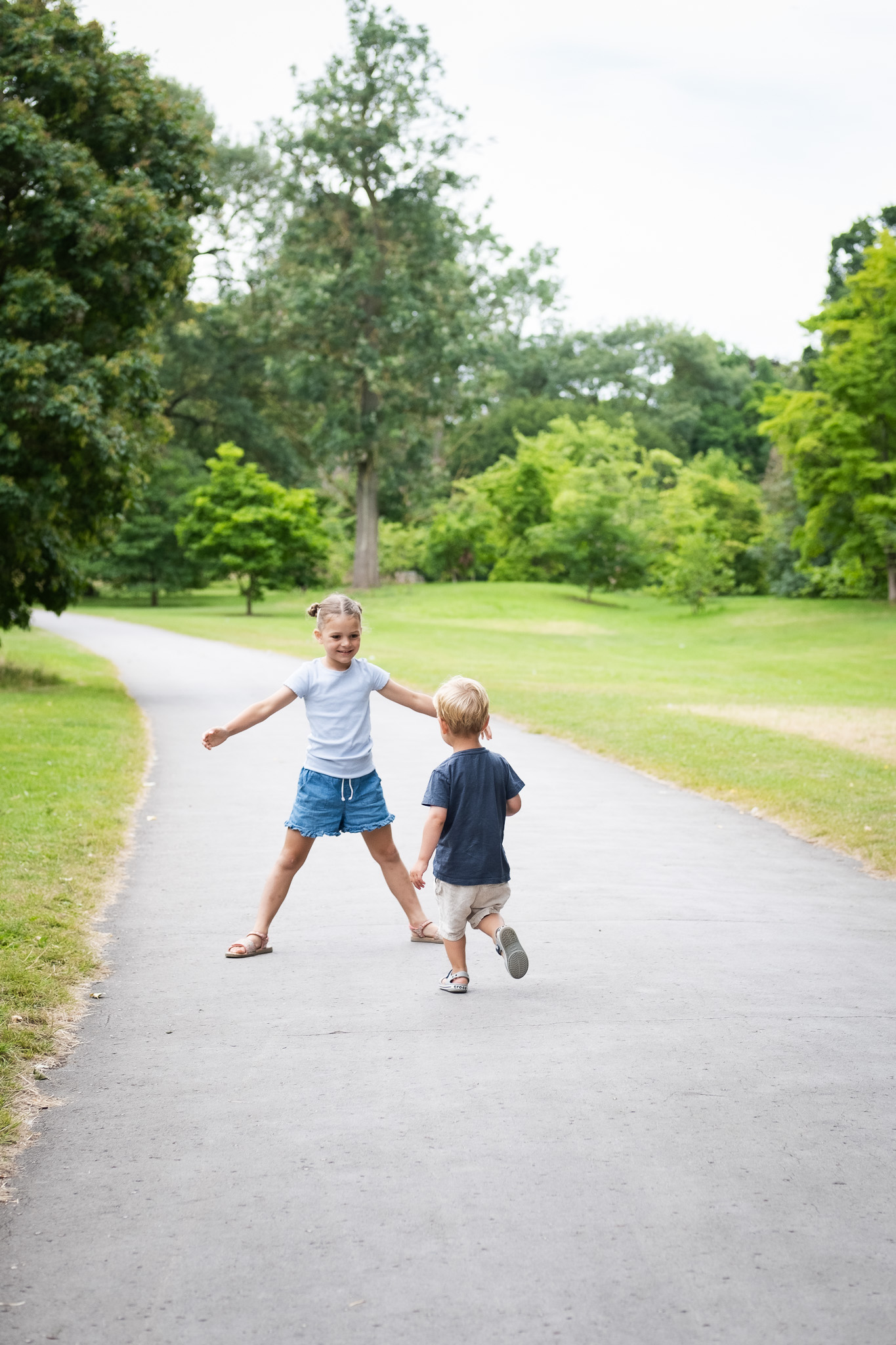 Little brother running to his big sister for a hug