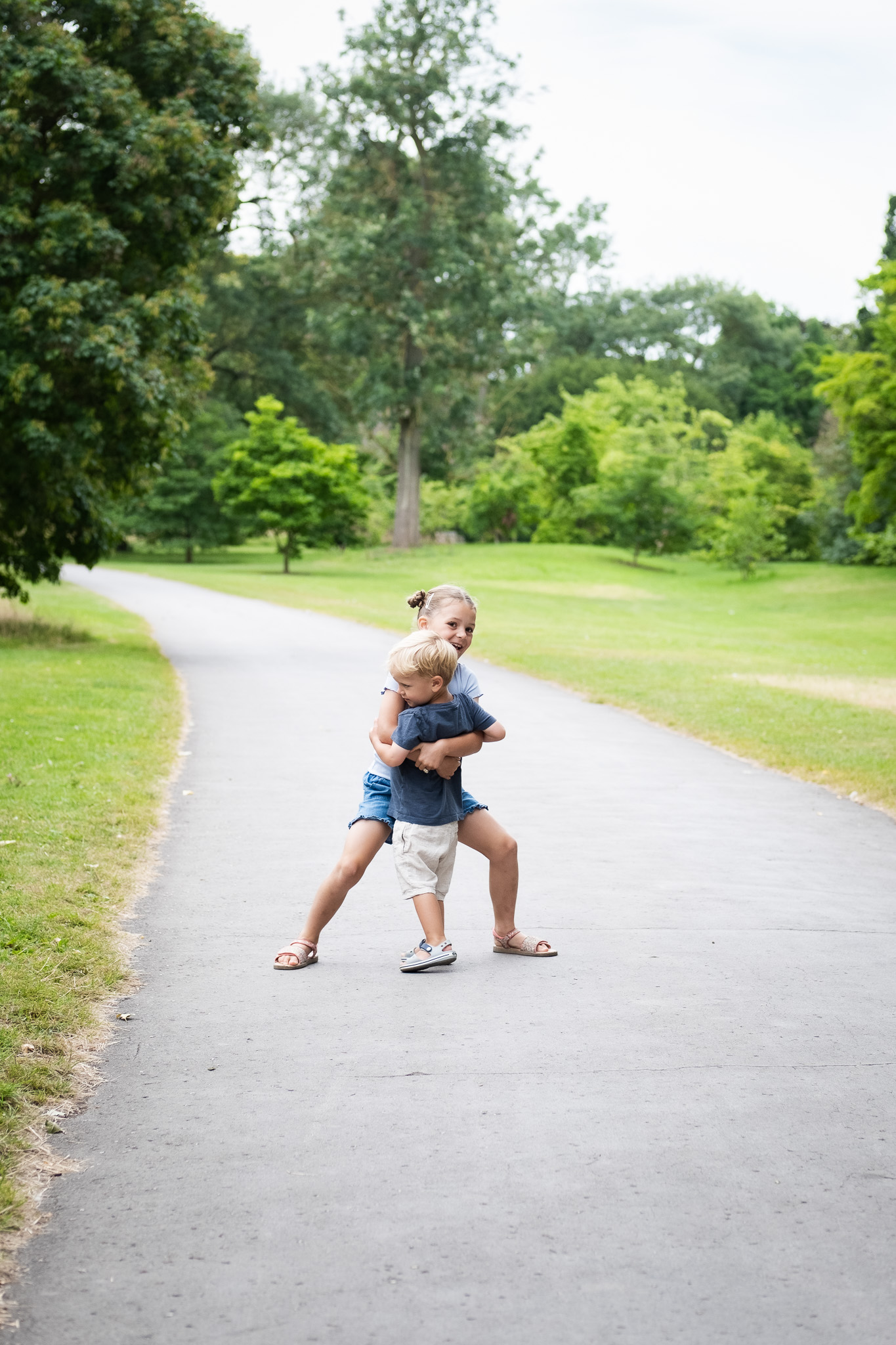 Little brother running to his big sister for a hug