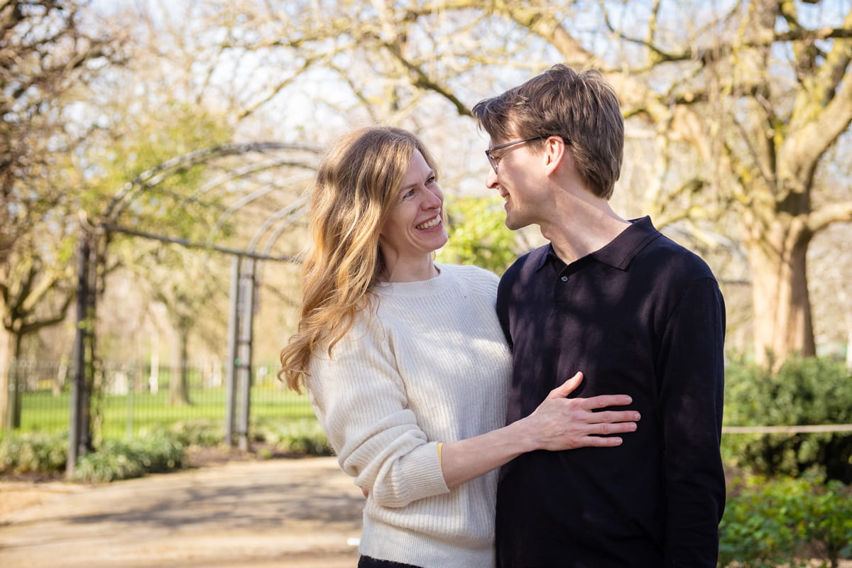 Romantic couple walking in Richmond Park during golden hour
