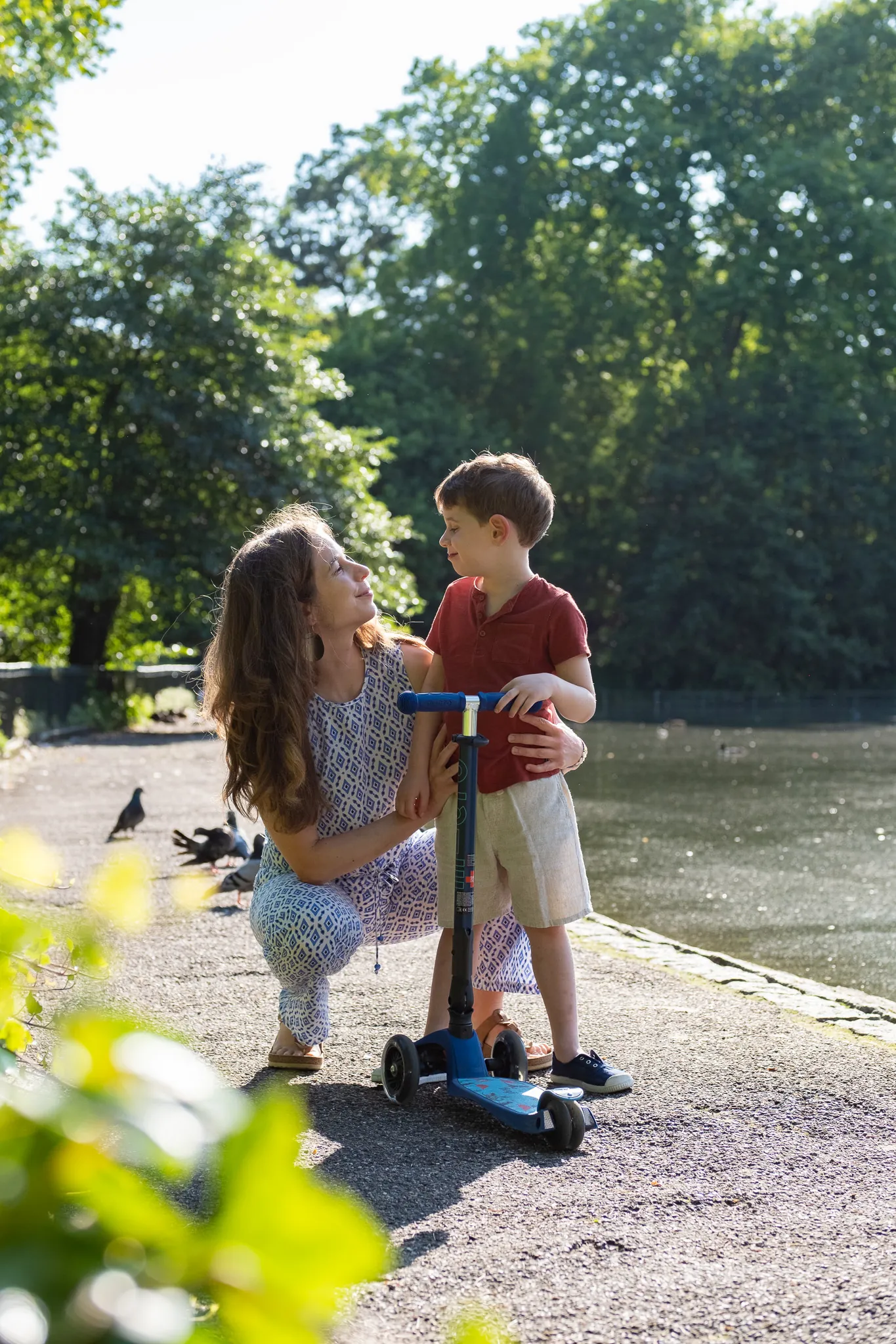 Mother and her son looking at each other in Battersea park by a lake