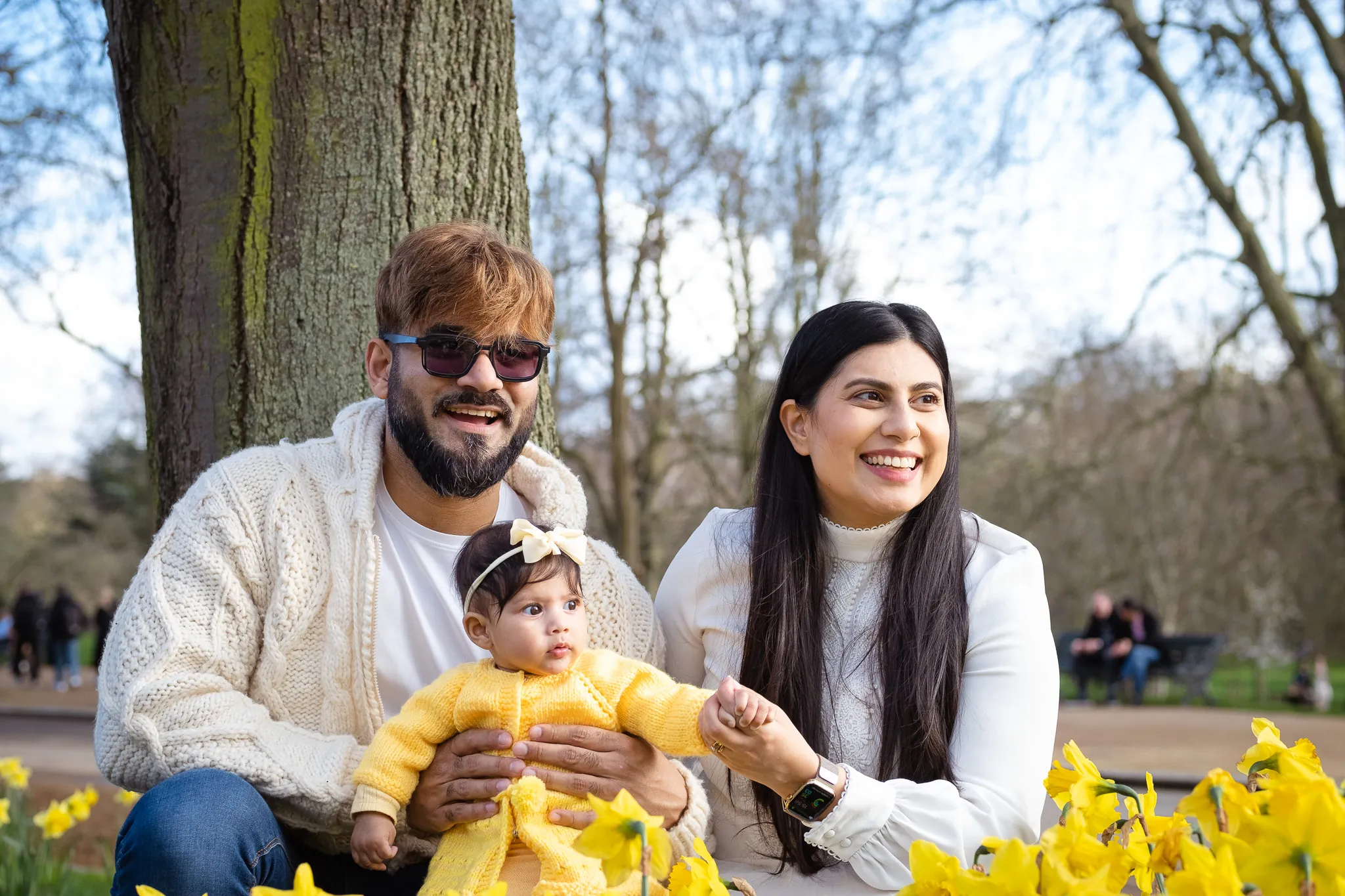 Family of three, by the daffodils flowers in Hyde Park