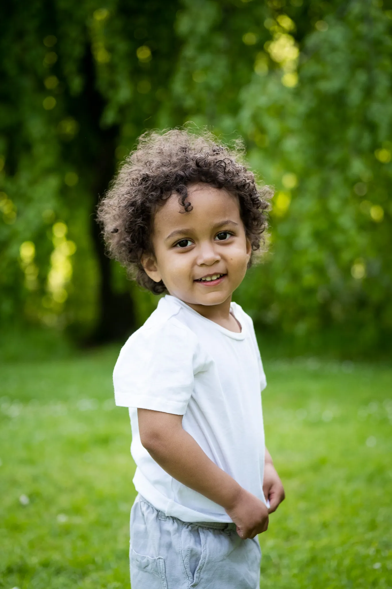 Little boy in a park for a family photoshoot with his family