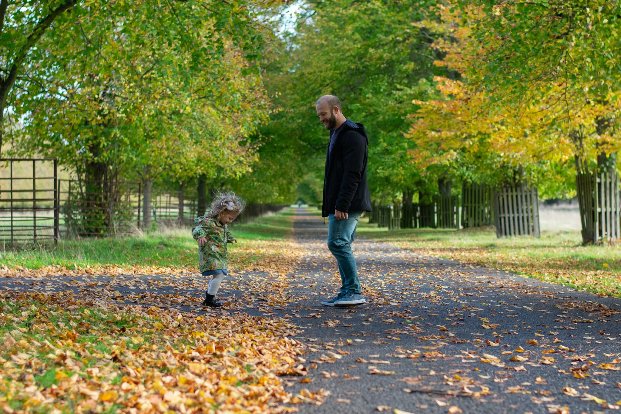 Father and his daughter in the park, during autumn photoshoot