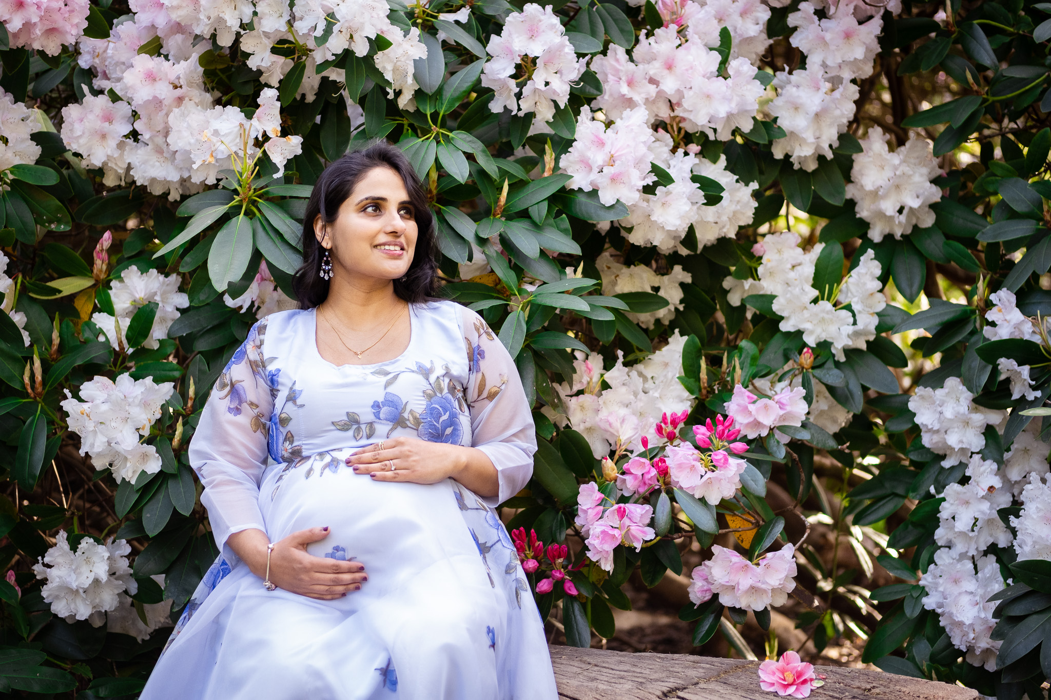 Pregnant woman surrounded by beautiful flowers