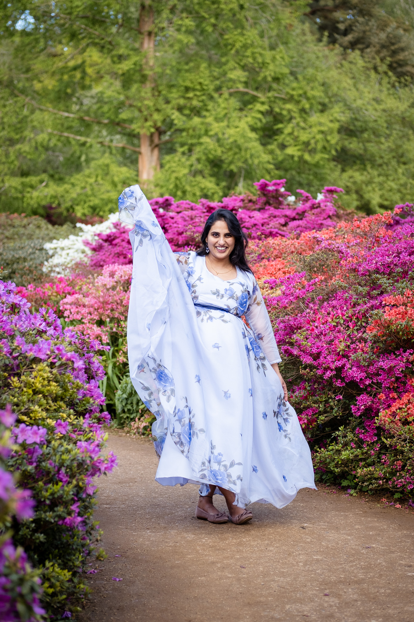 Pregnant woman surrounded by spring flowers